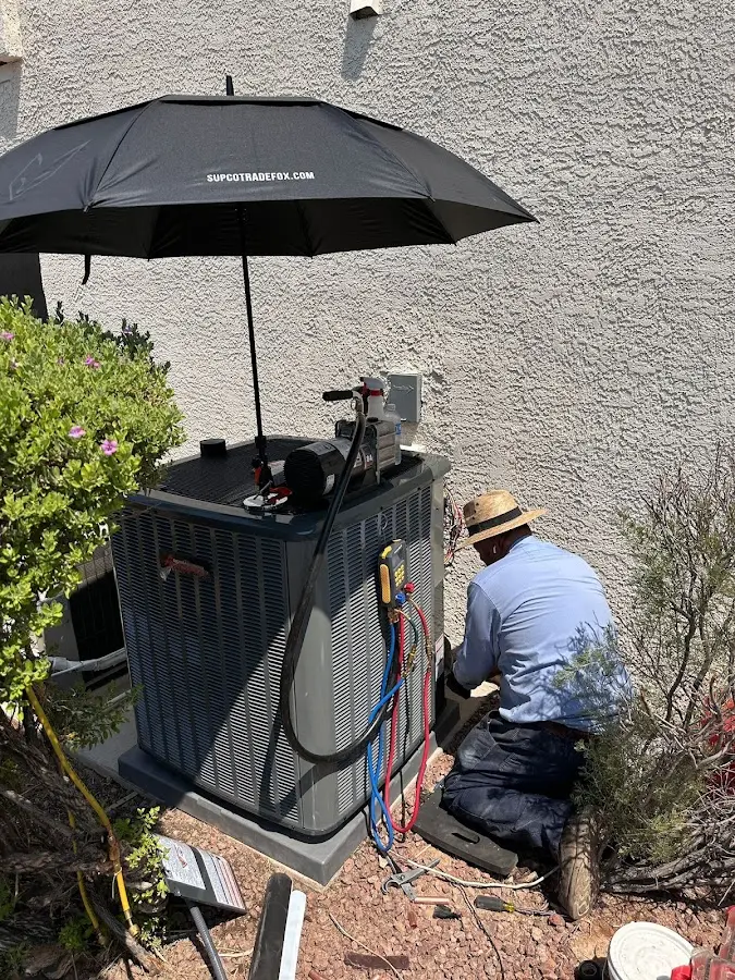 HVAC technician performing outdoor AC maintenance in Idaho Falls